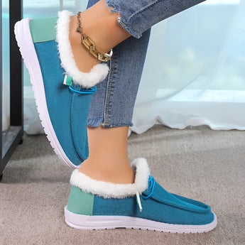 Women's turquoise slip-on shoes with fur lining, featuring a stylish winter design in shades of blue and black.