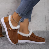 Women's turquoise slip-on shoes with fur lining, designed for winter; shown on a model's feet against a neutral background.
