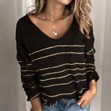 Women's V-neck white striped sweater in black, size 2XL, worn by a model paired with jeans, showcasing a chic fall fashion knitwear look with visible facial features like hair, skin, lips, and eyebrows.
