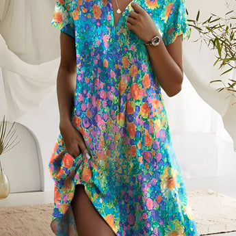 Women's short sleeve summer dress with a vibrant floral print, featuring a fitted waist and an azure color palette.