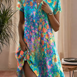 Women's vibrant floral print short sleeve summer dress in shades of blue and azure, showcasing a one-piece garment design. The dress features a flattering neckline and short sleeves, modeled with the focus on the shoulder and arm area.