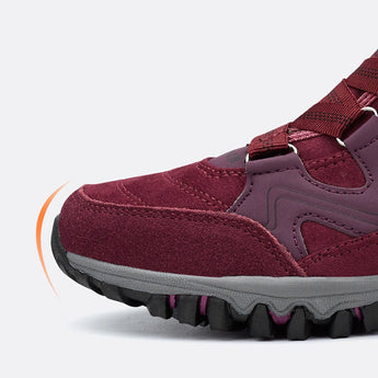 Women's waterproof insulated hiking boots in a stylish design with anti-slip soles, featuring vibrant magenta and electric blue colors suitable for outdoor activities.