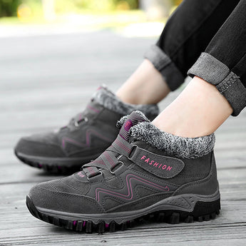 Women's black and grey waterproof insulated hiking boots designed for style and anti-slip performance, suitable for sportswear and outdoor activities.