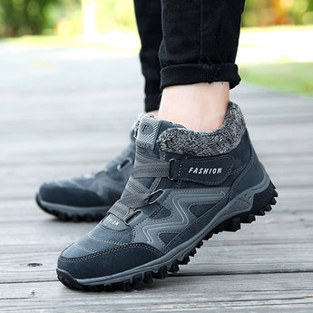 Women's waterproof insulated hiking boots in shades of white, black, and grey, designed for style and safety with an anti-slip sole, suitable for outdoor walking on various terrains, including grass.