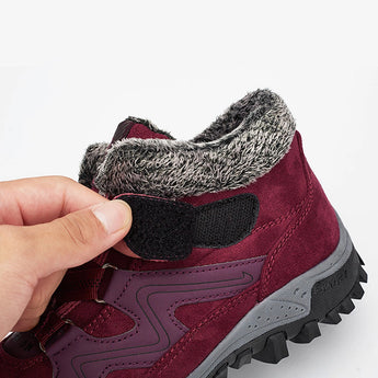 Women's waterproof insulated hiking boots in magenta color, featuring a stylish design with anti-slip synthetic rubber soles, woolen lining for warmth, and suitable for outdoor activities and sportswear.
