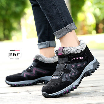 Women's waterproof insulated hiking boots in grey, featuring a stylish design and anti-slip soles, worn in a grassy outdoor setting.
