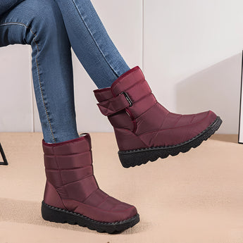 Women's waterproof insulated snow boots in pink, featuring a durable design with non-slip soles, providing thermal protection for winter weather.