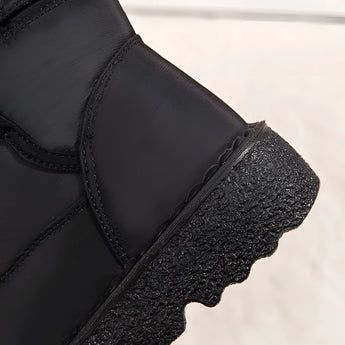 Women's grey waterproof insulated snow boots with non-slip soles and durable construction, suitable for outdoor winter activities.