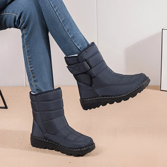 Women's waterproof insulated snow boots in electric blue, featuring a durable and non-slip sole. The boots are designed for thermal insulation, covering the leg up to the knee, providing warmth and traction in snowy conditions.