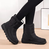 Women's waterproof insulated snow boots with non-slip soles, providing thermal protection and durability, shown on a model's legs.
