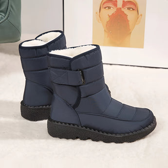 Women's grey waterproof insulated snow boots featuring a non-slip synthetic rubber sole, designed for comfort and durability in outdoor sportswear.