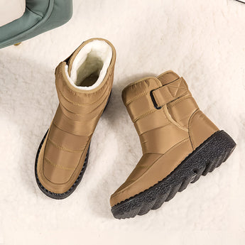 Brown women's waterproof insulated snow boots with a durable and non-slip design, featuring a fashion-forward look with beige accents, made from leather suitable for outdoor use.