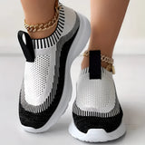 Women's white and black knit slip-on sneakers, featuring a breathable and lightweight design suitable for sportswear.