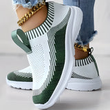 Women's white and black knit slip-on sneakers, featuring a lightweight and breathable design in a size 40.5, displayed in green color.