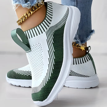 Women's white and black knit slip-on sneakers, featuring a lightweight and breathable design in a size 40.5, displayed in green color.