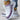 Women's purple knit slip-on sneakers with a breathable and lightweight design, featuring a white and black color scheme.