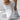 Women's white and black knit slip-on sneakers with rose accents, size 40.5, featuring a breathable and lightweight design suitable for sportswear and comfort.