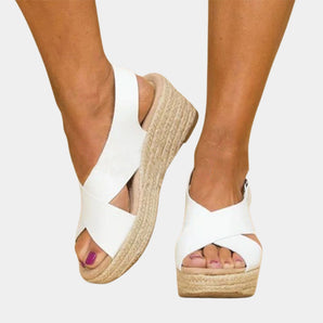 Women's white espadrille platform sandals featuring a lightweight design and open toe, shown worn on a model's feet.