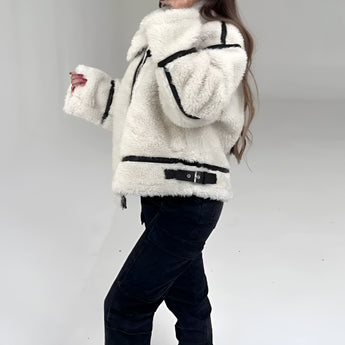 Women's white faux fur winter jacket with long sleeves, styled as cozy street wear.