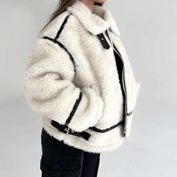 Women's white faux fur winter jacket with long sleeves and a cozy collar, showcasing stylish street wear design.