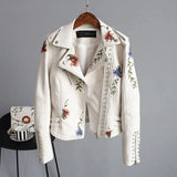 Women's beige floral embroidered leather bomber jacket in size XL, featuring a fashionable moto style with a soft collar, long sleeves, and intricate floral embroidery on a white leather base, perfect for spring outerwear.