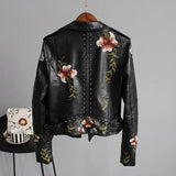 Women's white leather bomber jacket featuring intricate floral embroidery, showcasing a stylish spring moto design with a classic collar, full sleeves, and fitted waist.