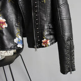 Women's white floral embroidered leather bomber jacket featuring a spring moto style with long sleeves, a collar, and intricate floral designs on the leather material.