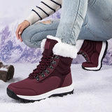 Women's wine red insulated snow boots with white fur lining, designed for winter with non-slip soles.