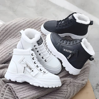 Women's white fur-lined lace-up ankle winter boots on a plain background.