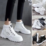 Women's white ankle winter boots with fur lining, lace-up design, and a black sole.