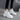 Women's white fur-lined lace-up ankle winter boots displayed with a focus on the sleek white exterior, cozy fur lining, and sturdy sole, suitable for cold weather.