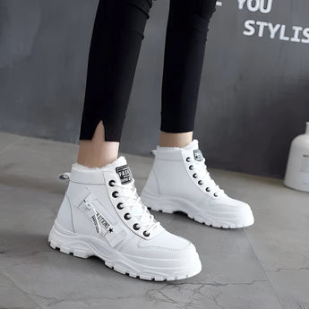 Women's white fur-lined lace-up ankle winter boots displayed with a focus on the sleek white exterior, cozy fur lining, and sturdy sole, suitable for cold weather.
