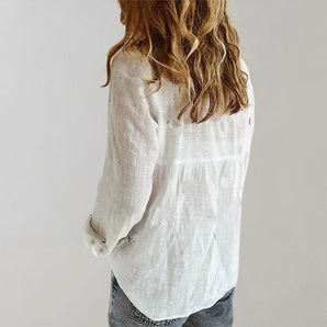 Women's white linen blouse with a lightweight and casual design, featuring a collar and long sleeves.