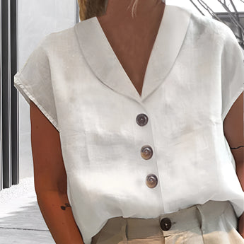 Women's white linen blouse with short sleeves, a V-neck, and button-down front, ideal for summer wear.