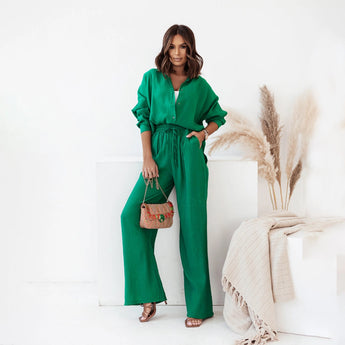 Women's green linen jumpsuit with a deep V-neck and drawstring waist, featuring short sleeves and a relaxed fit, suitable for summer events.