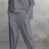 Women's gray lounge set featuring a minimalist sweatshirt with relaxed joggers, shown in size 3XL. The set highlights a comfortable fit with long sleeves and a relaxed waistline.