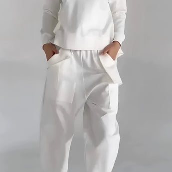 Women's white lounge set featuring a minimalist sweatshirt with long sleeves and relaxed joggers, designed for comfort and style; displayed in a 3XL size.