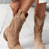 Women's white perforated studded cowgirl ankle boots with a summer western design.