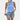 
A woman wearing a white pleated high neck blouse paired with distressed denim shorts in blue, showcasing an XL size.