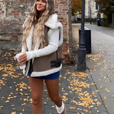 Women's white shearling vest styled with urban chic winter fashion, featuring visible shoulder and sleeve detail, worn by a model possibly with eyewear against a natural backdrop.