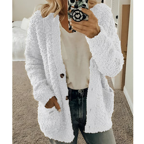
A women's white teddy coat in a soft plush material, featuring a fluffy texture with long sleeves.