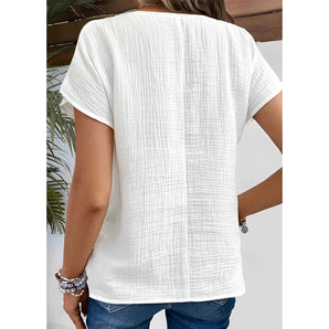 Women's white textured short sleeve t-shirt with loose fit and breathable fabric.