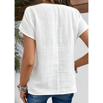 Women's white textured short sleeve t-shirt with loose fit and breathable fabric.