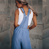 Women's wide-leg blue denim overalls with pockets, featuring adjustable shoulder straps and a relaxed fit at the waist and thighs.