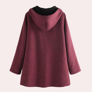 
A women's wine red oversized hooded coat made from a wool blend, featuring a loose fit with long sleeves and a large hood, suitable for outerwear.