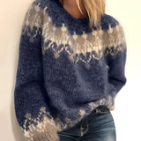 
A cozy wool ombre hand-knit chunky pullover sweater in shades of blue and grey, with long sleeves and a comfortable neckline, shown in a size 3XL.