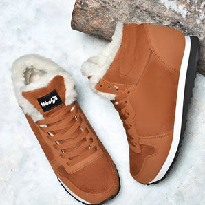 Brown and orange wool-lined fur boots designed for outdoor use, featuring a snow-resistant insulated exterior, suitable for walking in cold weather.