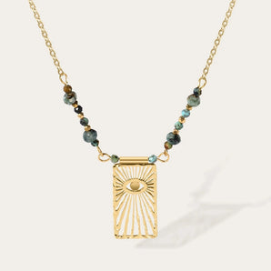 YA-CHAN 18K gold beaded chain necklace with turquoise and eye motif in gold tone, featuring intricate beadwork and vibrant electric blue accents.