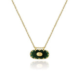Elegant green gemstone pendant on a gold chain, luxury emerald necklace.