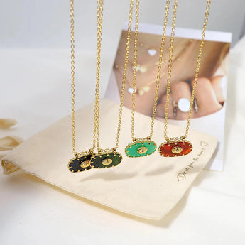 Luxury emerald necklace with a green gemstone pendant on a gold chain.